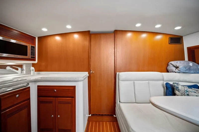 Slide: The Image of Luxurious interior of 2005 Cabo 40 Express yacht with modern kitchen and seating area. - 57