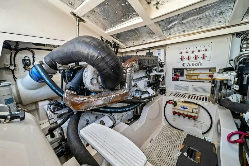 Slide: The Image of Engine room of a 2005 Cabo 40 Express boat, showcasing detailed machinery and components. - 58