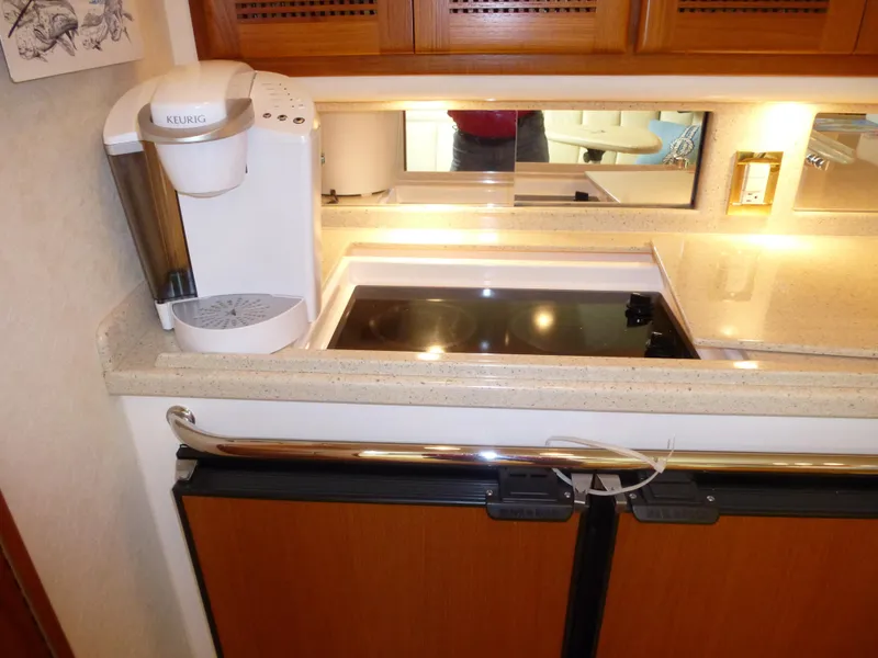 Slide: The Image of 2005 Cabo 40 Express yacht helm with modern controls and ocean view. - 6