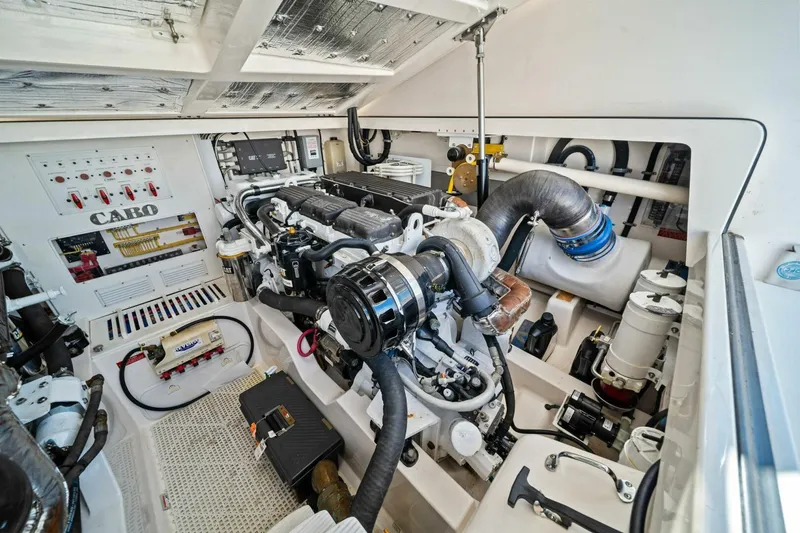 Slide: The Image of Engine room of a 2005 Cabo 40 Express boat, showcasing detailed mechanical components. - 60