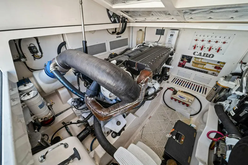 Slide: The Image of Engine room of 2005 Cabo 40 Express boat, showcasing detailed mechanical components. - 61
