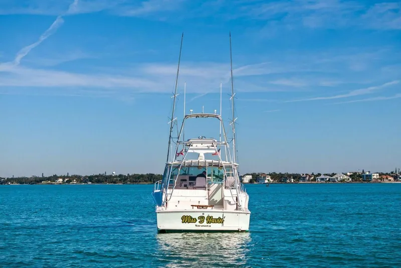 Slide: The Image of 2005 Cabo 40 Express boat on calm blue water under clear sky. - 62
