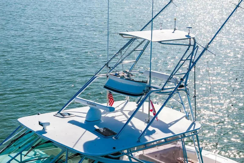 Slide: The Image of 2005 Cabo 40 Express boat with tower on sparkling water. - 65