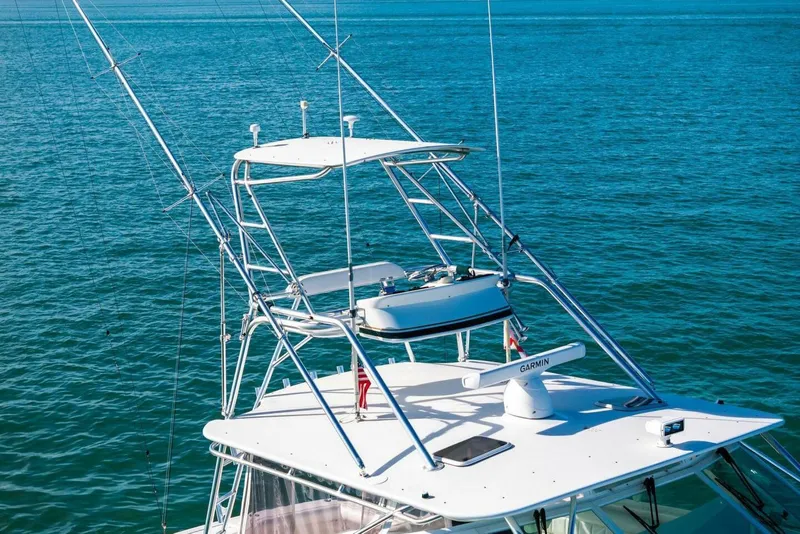 Slide: The Image of 2005 Cabo 40 Express boat with tower and Garmin equipment on open sea. - 66