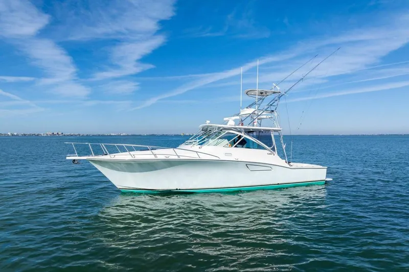 Slide: The Image of 2005 Cabo 40 Express yacht on calm blue waters under clear sky. - 69