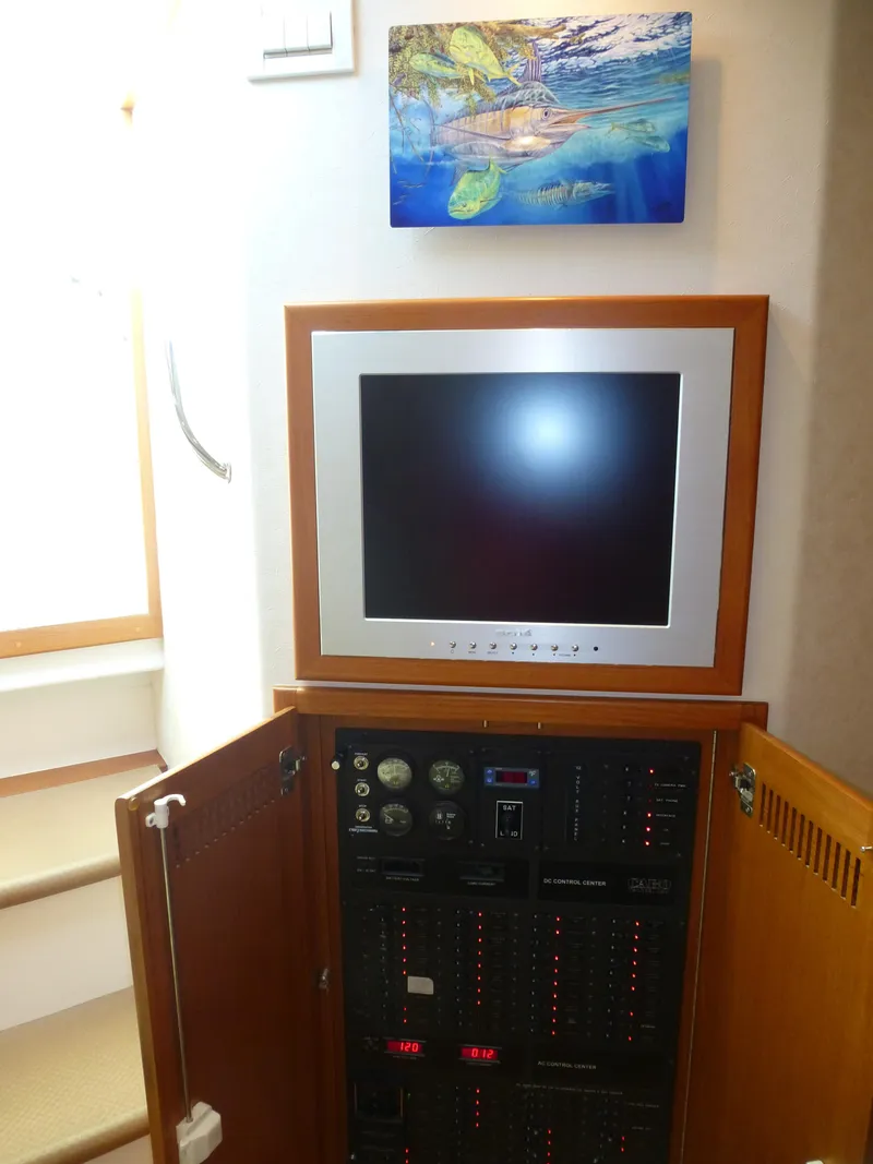 Slide: The Image of 2005 Cabo 40 Express helm with modern navigation equipment and ocean view. - 7