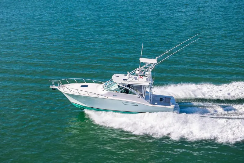 Slide: The Image of 2005 Cabo 40 Express boat cruising on open water. - 73