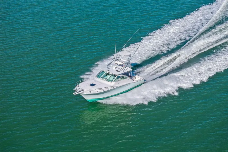 Slide: The Image of 2005 Cabo 40 Express boat cruising swiftly on open water. - 74