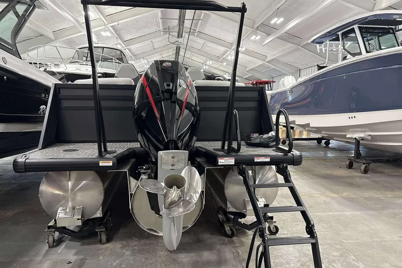 Slide: The Image of 2026 Viaggio x22u boat in showroom, featuring powerful outboard motor and sleek design. - 28