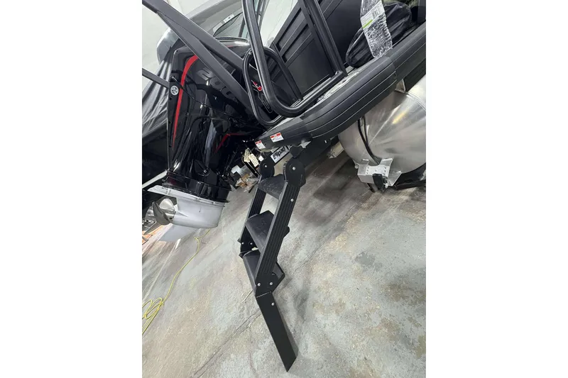 Slide: The Image of 2026 Viaggio x22u boat with motor and boarding ladder in a garage setting. - 32