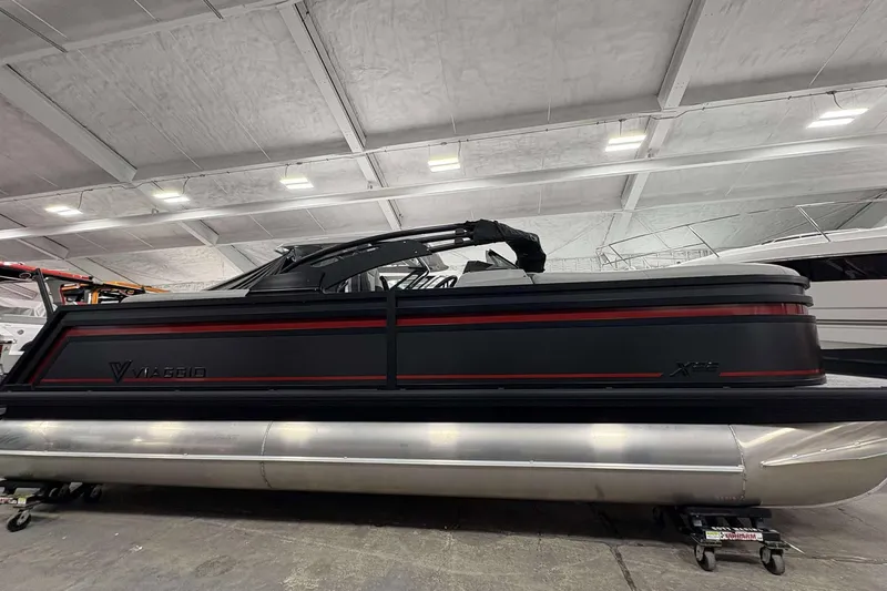 Slide: The Image of 2026 Viaggio x22u pontoon boat in a showroom, featuring sleek black and red design. - 4