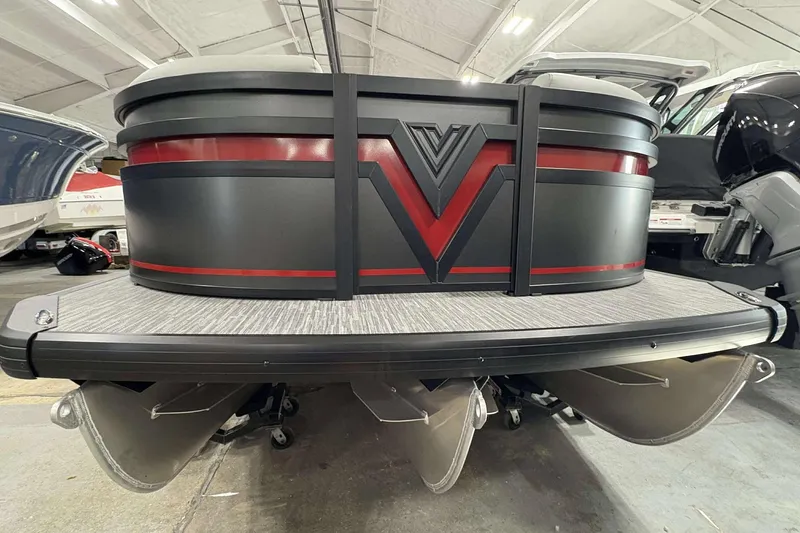 Slide: The Image of 2026 Viaggio x22u pontoon boat with sleek design and red accents in a showroom. - 5