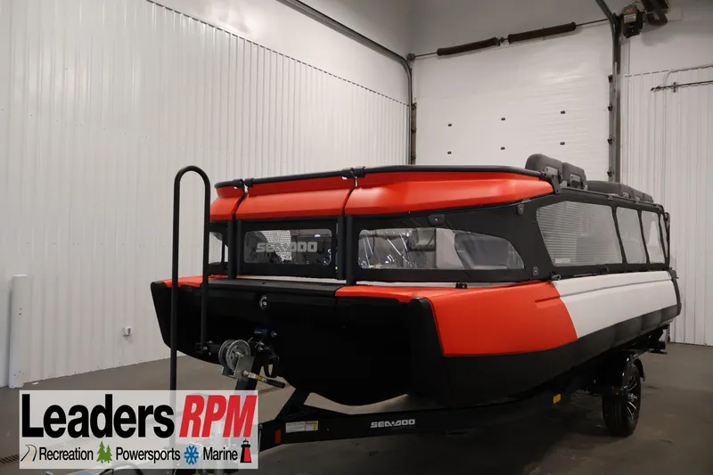 The Image of 2024 Sea-Doo Switch 19 pontoon boat in a showroom, featuring a red and black design. - 0