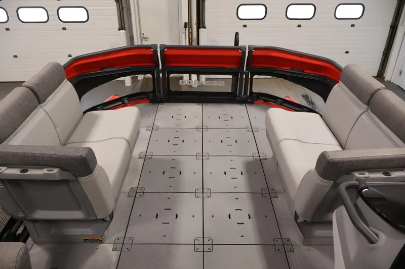 Slide: The Image of 2024 Sea-Doo Switch 19 pontoon boat with spacious seating and modern design in a garage setting. - 10
