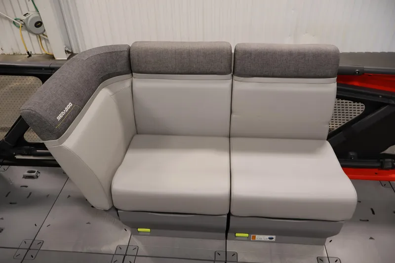 Slide: The Image of 2024 Sea-Doo Switch 19 pontoon boat in a showroom, side view. - 11