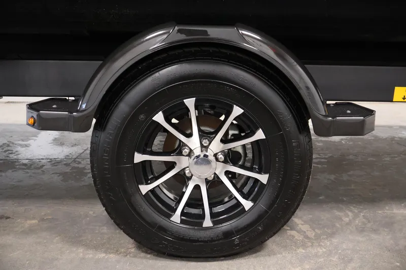 Slide: The Image of 2024 Sea-Doo Switch 19 trailer wheel with black and silver alloy design. - 30