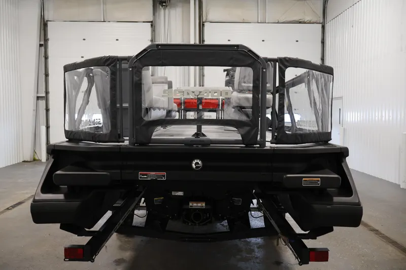 Slide: The Image of 2024 Sea-Doo Switch 19 pontoon boat in a garage, featuring a vibrant red and black design. - 5