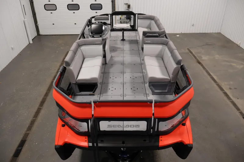 Slide: The Image of 2024 Sea-Doo Switch 19 pontoon boat with spacious seating and modern design in a garage. - 8