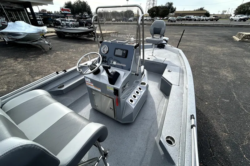Slide: The Image of 2025 Xpress H20B Bay boat interior with steering console and seating. - 12