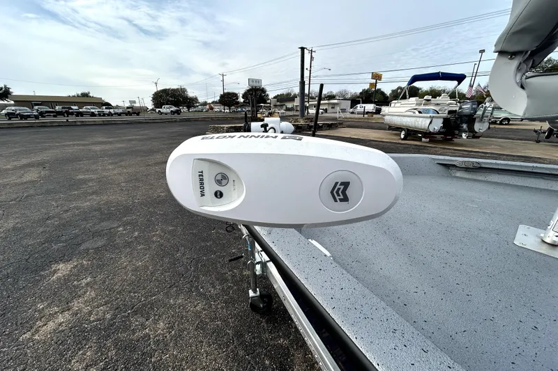 Slide: The Image of 2025 Xpress H20B Bay boat with Minn Kota Terrova trolling motor in a dealership lot. - 14
