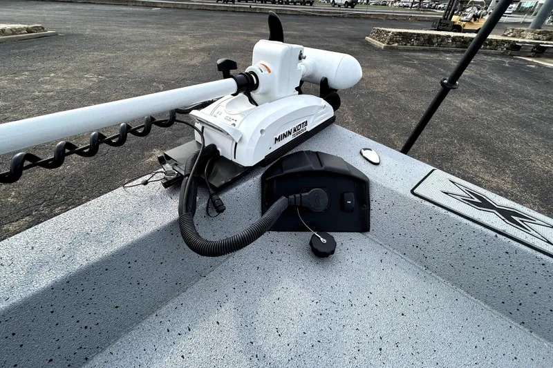 Slide: The Image of 2025 Xpress H20B Bay boat with Minn Kota trolling motor on deck. - 15