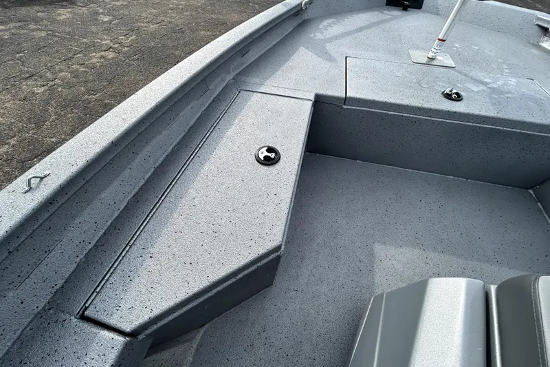 Slide: The Image of 2025 Xpress H20B Bay boat interior with gray textured flooring and storage compartments. - 16