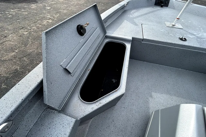 Slide: The Image of 2025 Xpress H20B Bay boat storage compartment with open lid on deck. - 17