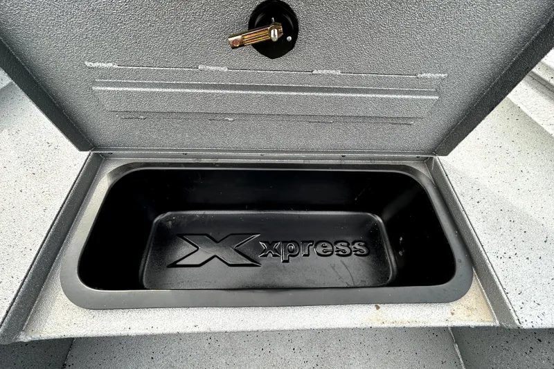 Slide: The Image of Open storage compartment in 2025 Xpress H20B Bay boat, featuring Xpress branding. - 19