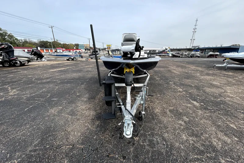 Slide: The Image of 2025 Xpress H20B Bay boat on trailer in parking lot, front view. - 2