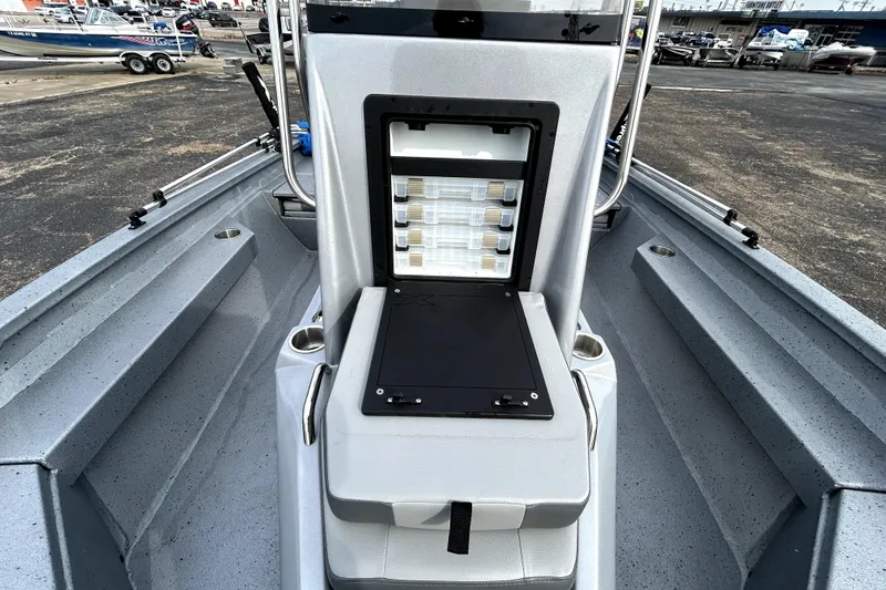 Slide: The Image of 2025 Xpress H20B Bay boat interior with open storage compartment, showcasing organized tackle boxes. - 24