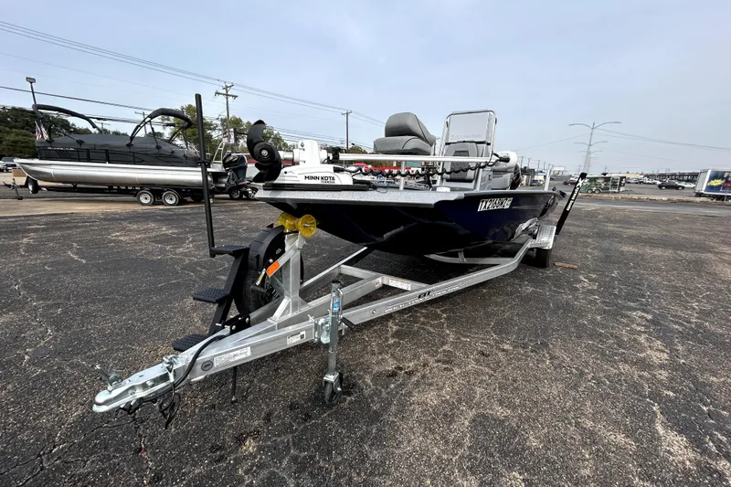 Slide: The Image of 2025 Xpress H20B Bay boat on trailer, featuring Minn Kota trolling motor. - 3