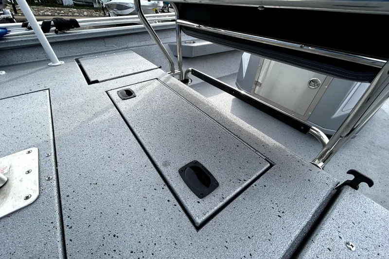 Slide: The Image of 2025 Xpress H20B Bay boat deck with storage compartments and seating area. - 37
