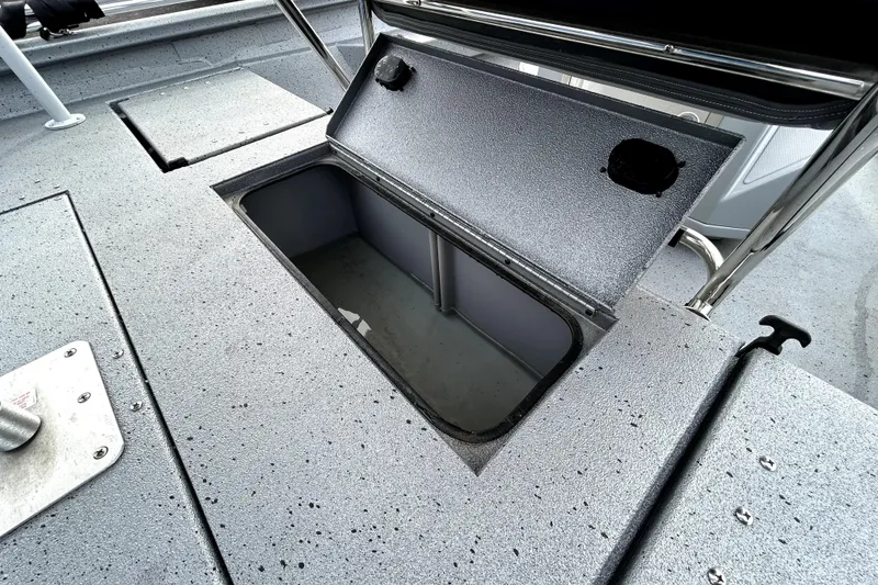 Slide: The Image of Open storage compartment on 2025 Xpress H20B Bay boat deck. - 38