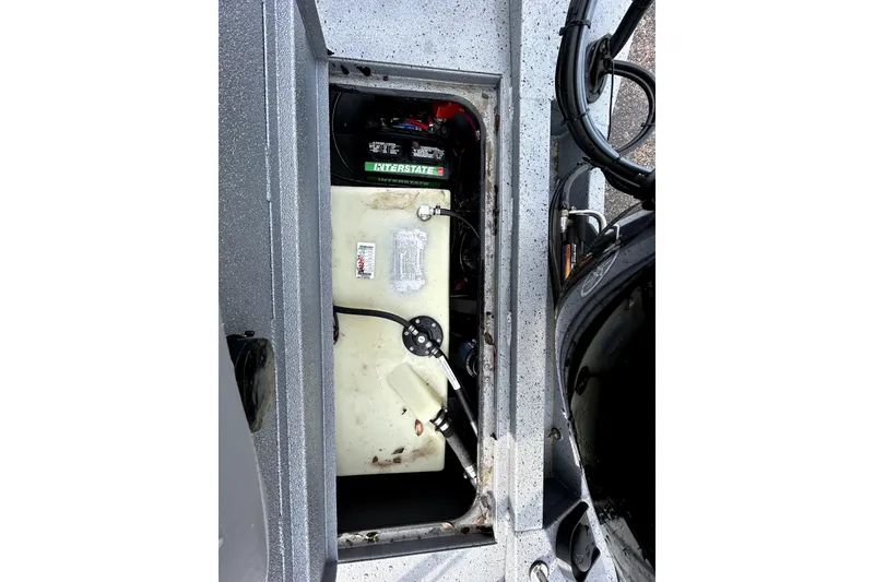 Slide: The Image of 2025 Xpress H20B Bay boat interior showing battery and storage compartment. - 40