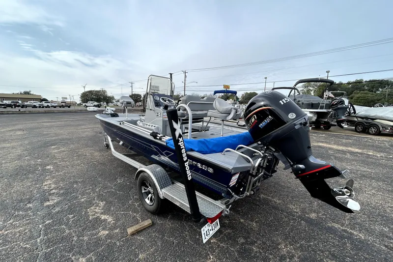 Slide: The Image of 2025 Xpress H20B Bay boat with Yamaha 115 engine on trailer. - 5