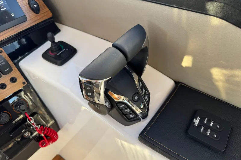 Slide: The Image of 2025 Cutwater C-288 Coupe boat controls with joystick and throttle levers. - 18