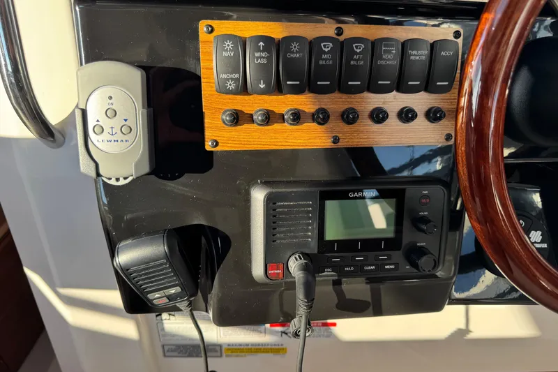 Slide: The Image of 2025 Cutwater C-288 Coupe dashboard with controls and Garmin display. - 19