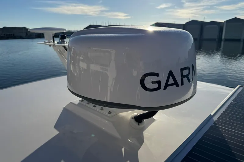 Slide: The Image of 2025 Cutwater C-288 Coupe with Garmin radar on deck, docked by the water. - 26