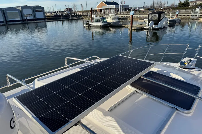 Slide: The Image of 2025 Cutwater C-288 Coupe with solar panels docked at a marina. - 27