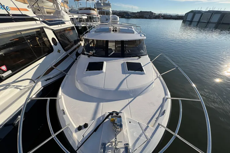 Slide: The Image of 2025 Cutwater C-288 Coupe boat docked in a marina, surrounded by other vessels. - 28