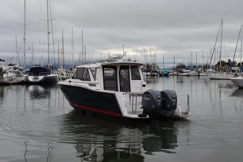 Slide: The Image of 2025 Cutwater C-288 Coupe boat in marina, overcast sky, dual Yamaha engines. - 3