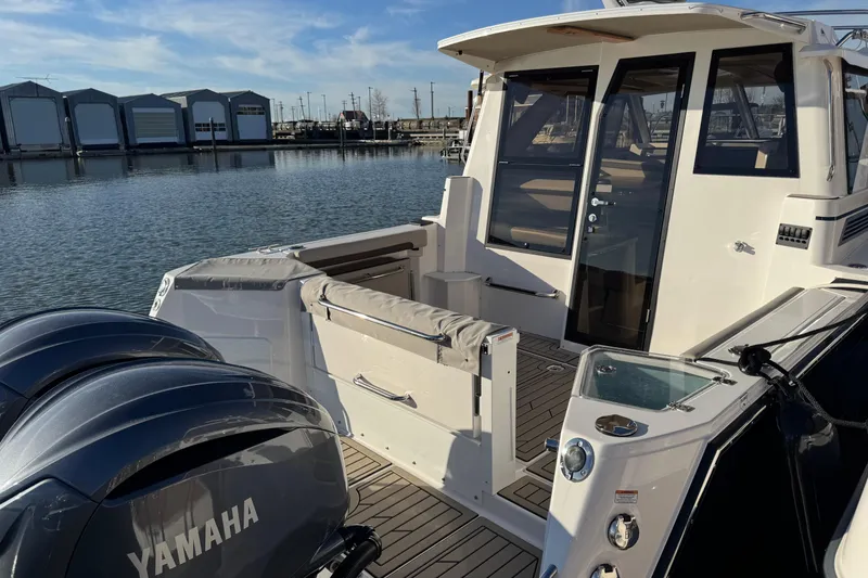 Slide: The Image of 2025 Cutwater C-288 Coupe boat with Yamaha engines docked at marina. - 5