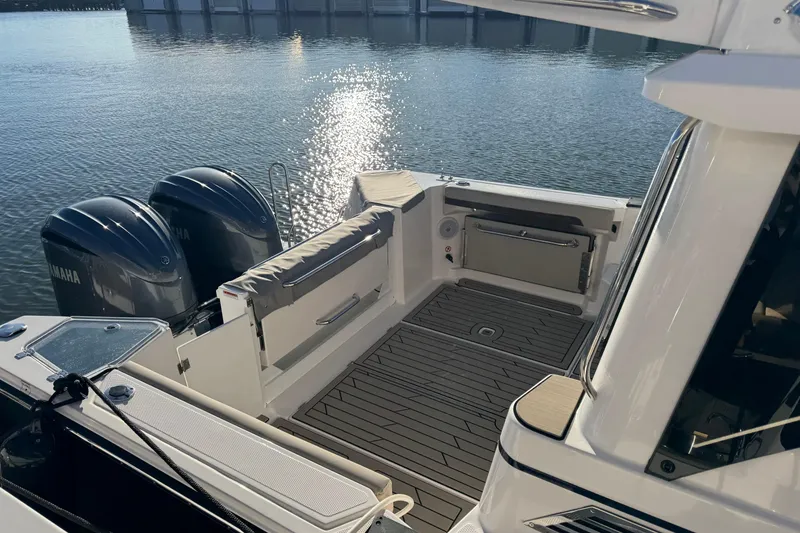 Slide: The Image of 2025 Cutwater C-288 Coupe boat with Yamaha engines, docked on calm water. - 6