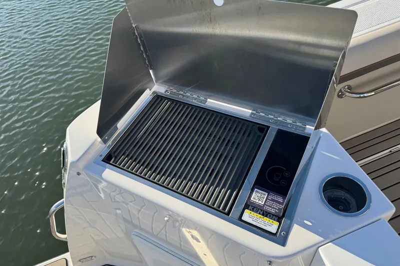 Slide: The Image of Outdoor grill on 2025 Cutwater C-288 Coupe boat, docked by the water. - 8
