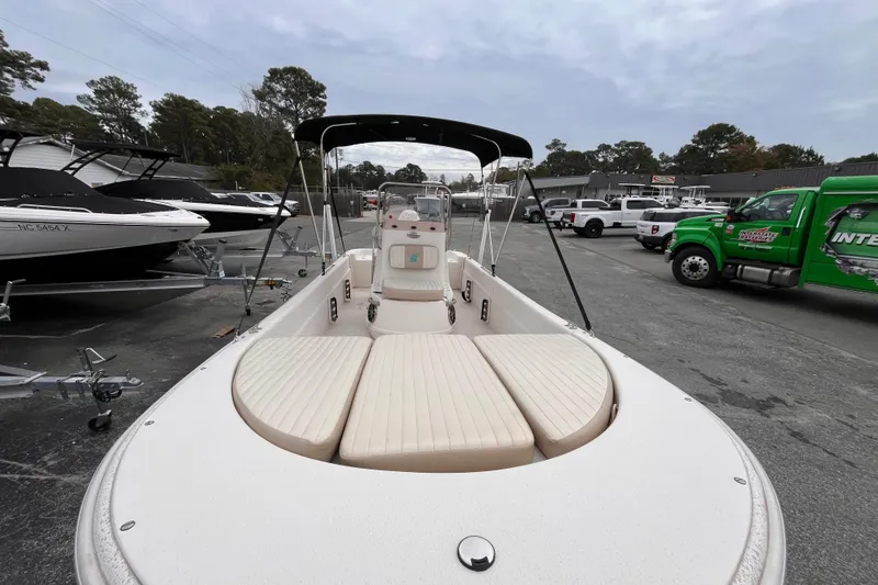 Slide: The Image of 2019 Carolina Skiff 20 JVX CC boat with seating, parked outdoors. - 11