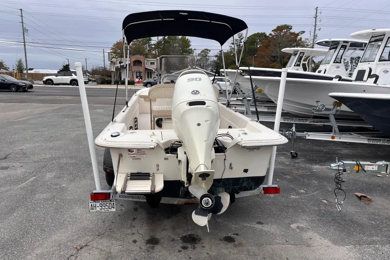 Slide: The Image of 2019 Carolina Skiff 20 JVX CC boat with outboard motor, parked on a trailer. - 3