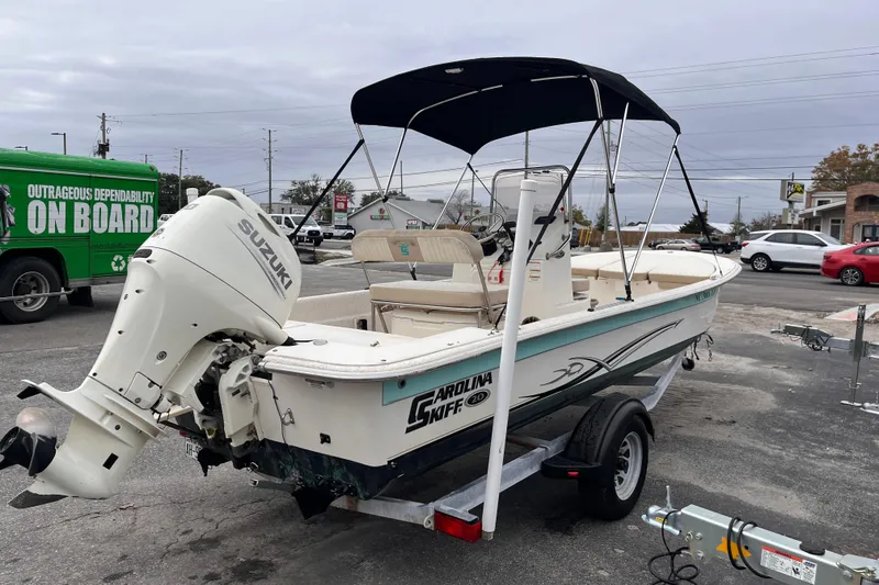 Slide: The Image of 2019 Carolina Skiff 20 JVX CC boat with Suzuki outboard motor on trailer. - 4