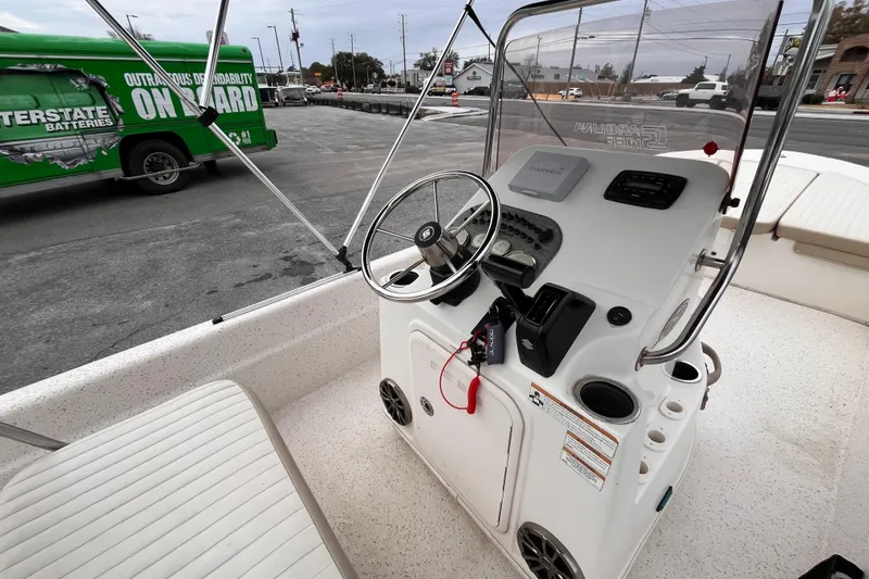 Slide: The Image of 2019 Carolina Skiff 20 JVX CC boat console with steering wheel and controls. - 7