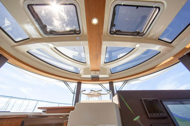 Slide: The Image of Manufacturer Provided Image: Interior view of 2025 Ranger Tugs R-29 CB with skylights and modern design. - 7