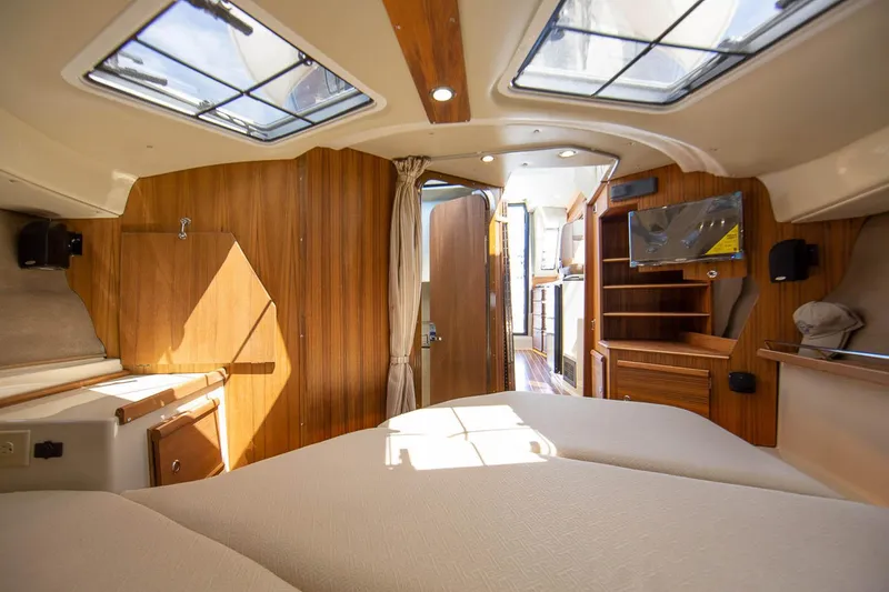 Slide: The Image of Manufacturer Provided Image: Interior of 2025 Ranger Tugs R-29 CB, featuring cozy cabin with wood accents and skylights. - 9